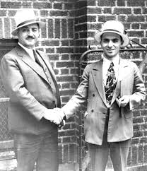 Pete Carlino (left) shakes hands with Joe Roma (right) after Roma posted his $5,000 bond in 1933