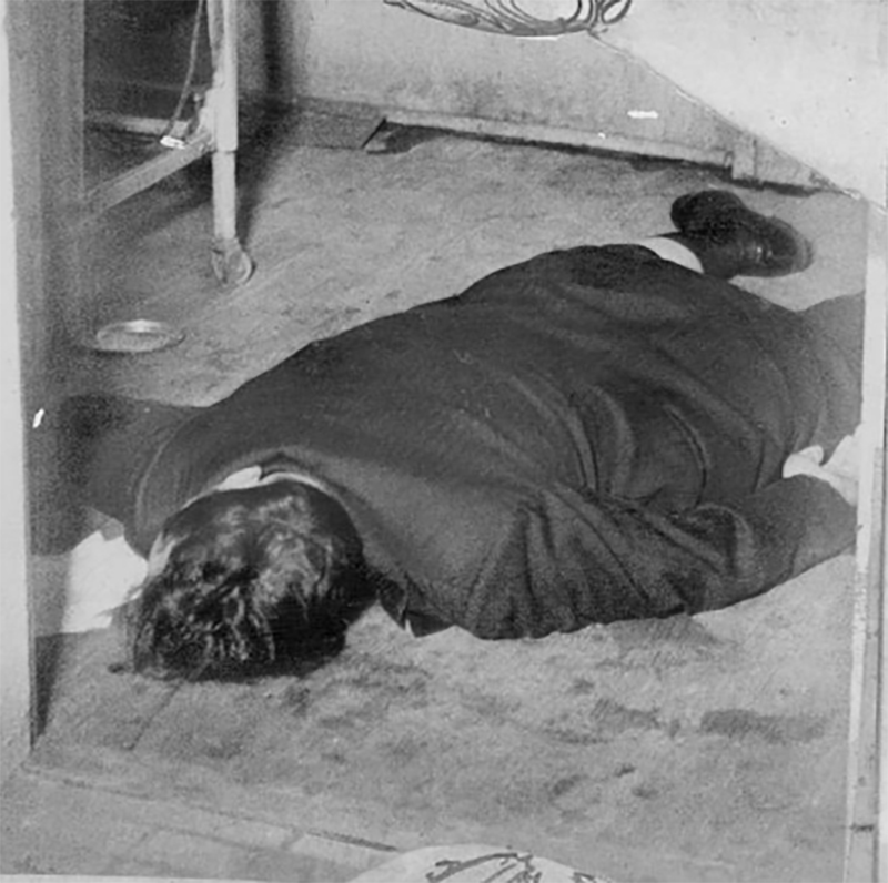 Sam Carlino lies dead on the floor of his home.