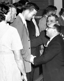 Clyde Smaldone and his defense attorney shake hands with jurors in courtroom celebration which followed the acquittal verdict in 1953.