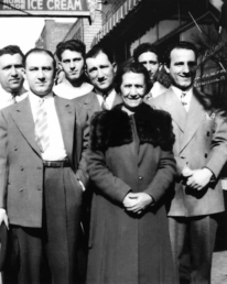 Mamie Smaldone stands with her six sons, from left, Clyde, Anthony, Clarence, Eugene, Andrew, and Ralph, in front of the family bar on Tejon Street in about 1940. Photo Credit: Smaldone: The Untold Story of an American Crime Family.